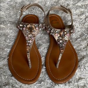 Cute gold thong sandals with ankle straps. Guess